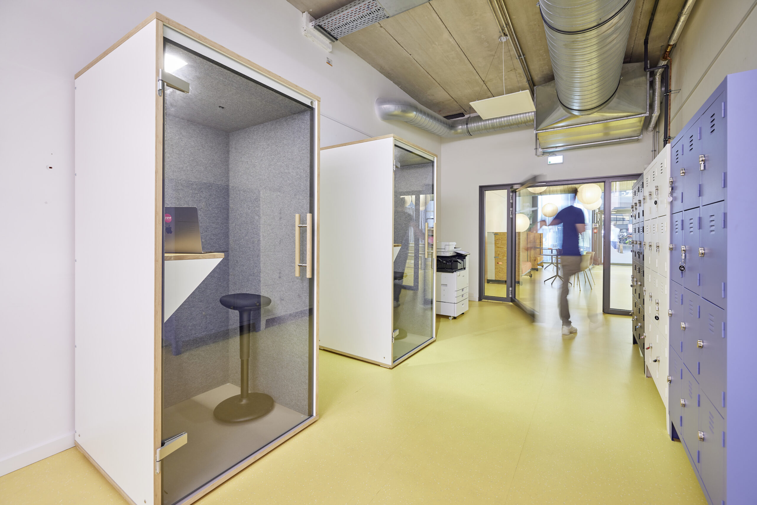 Flur mit Spinden und Telefonzellen.